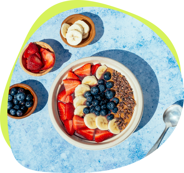 Image of smoothie bowl with strawberries, banana, blueberries, and oats.